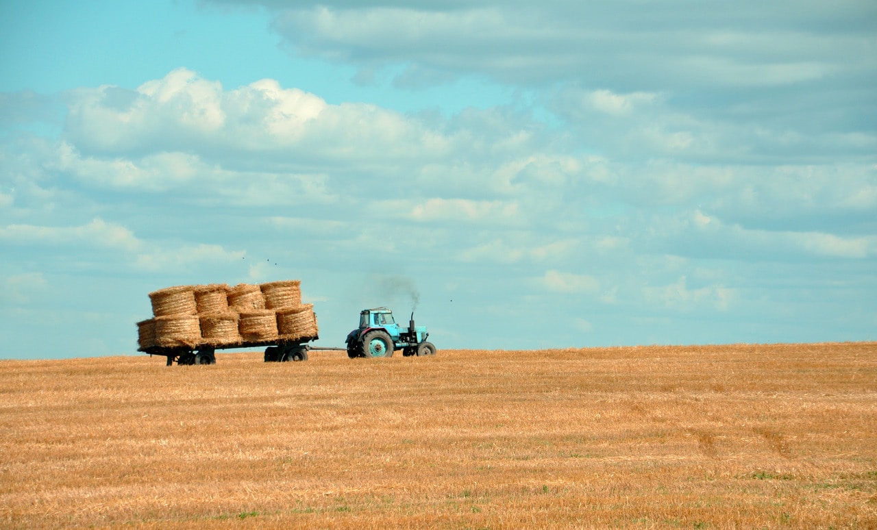 Tractor working across open farmland