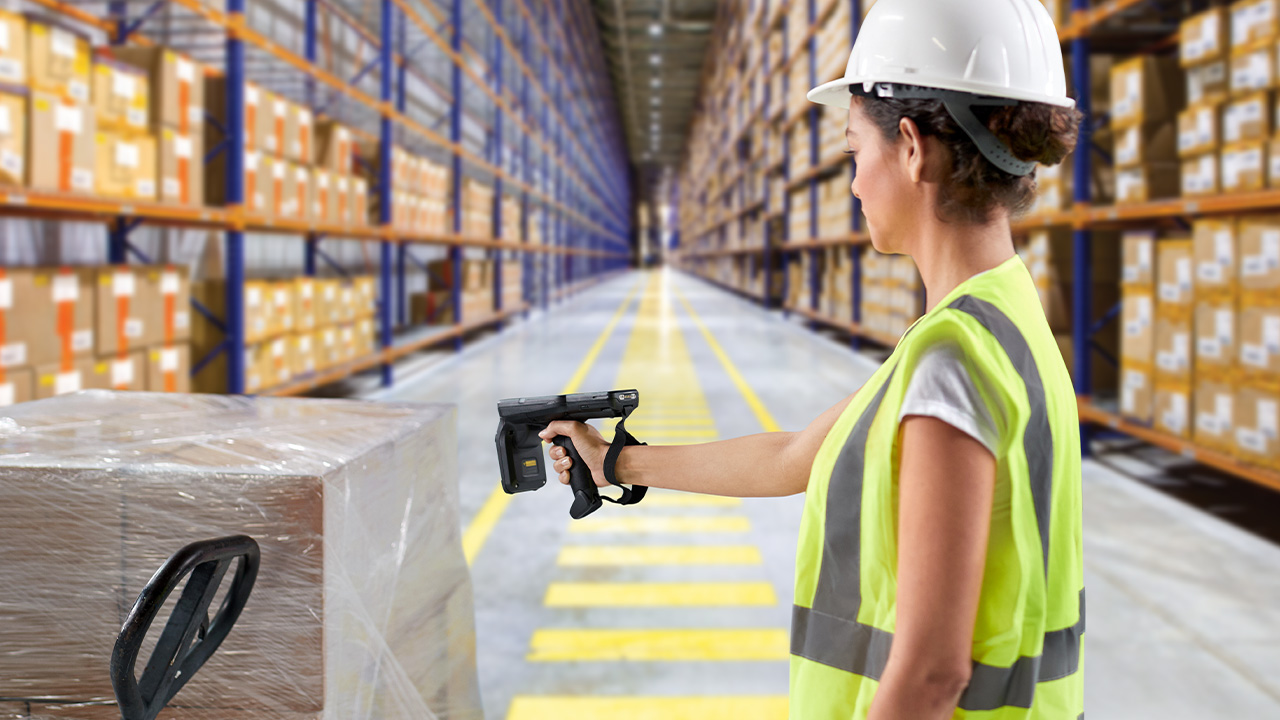 Worker scanning a pallet with a handheld RFID reader at the dock