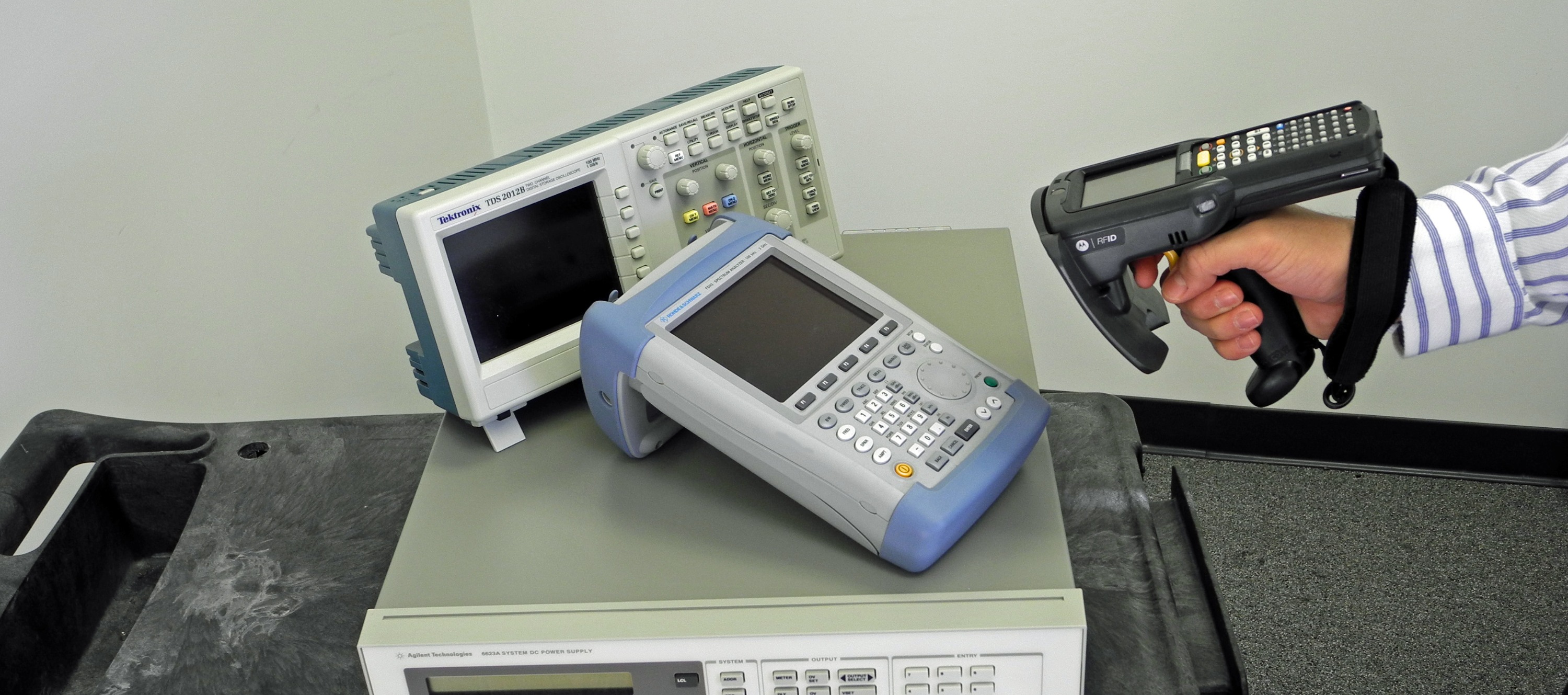 Handheld RFID reader scanning tagged equipment